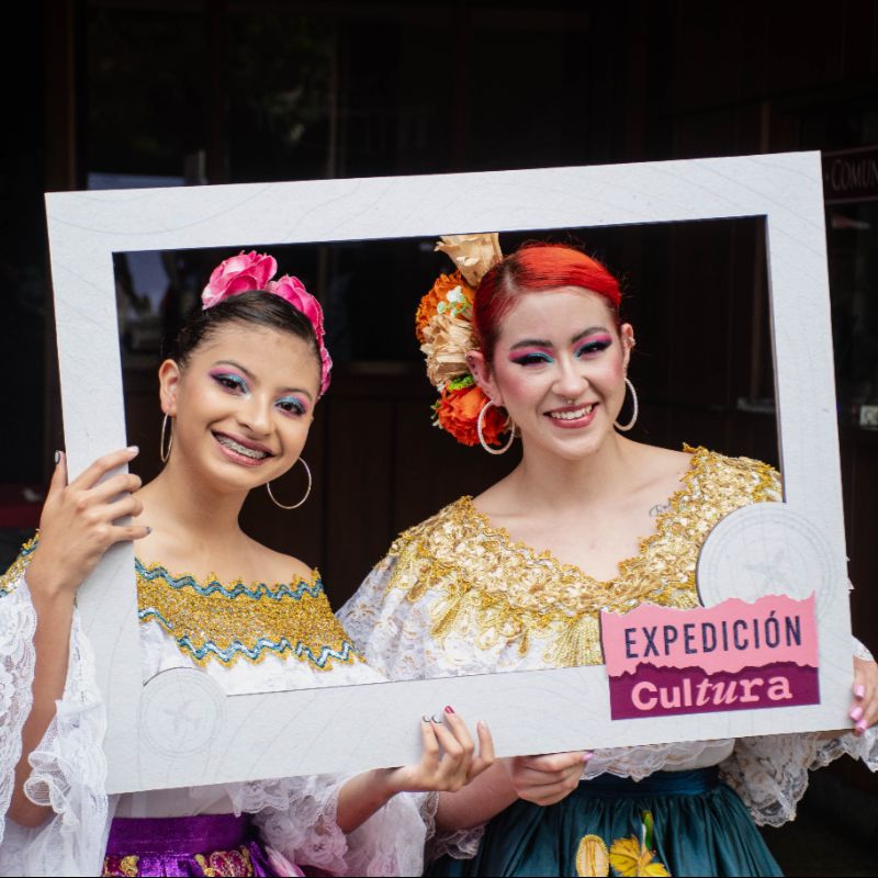 Dos mujeres sosteniendo un cartel que dice expedición cultura